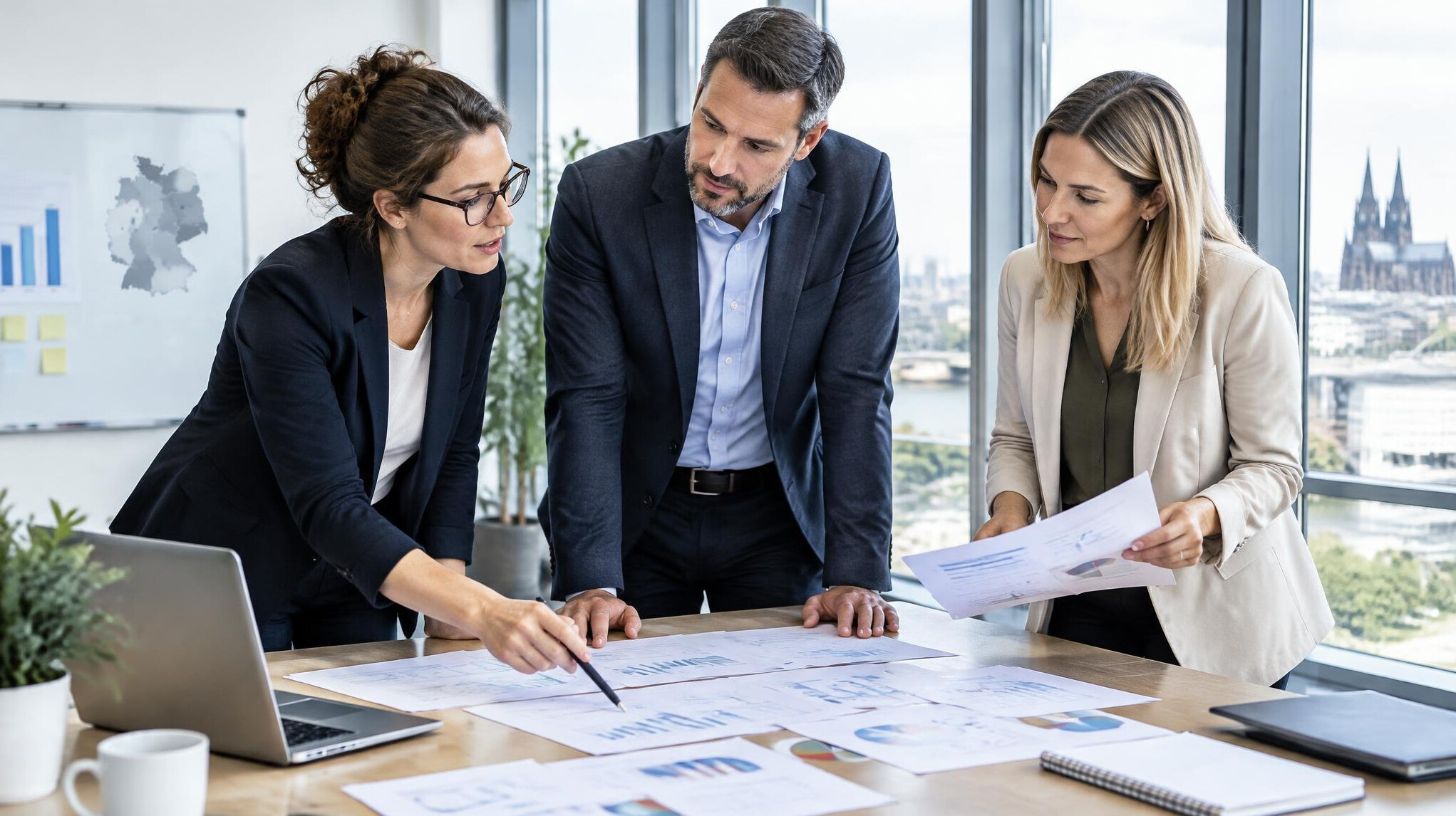 Researchers discussing audience survey results in a modern office