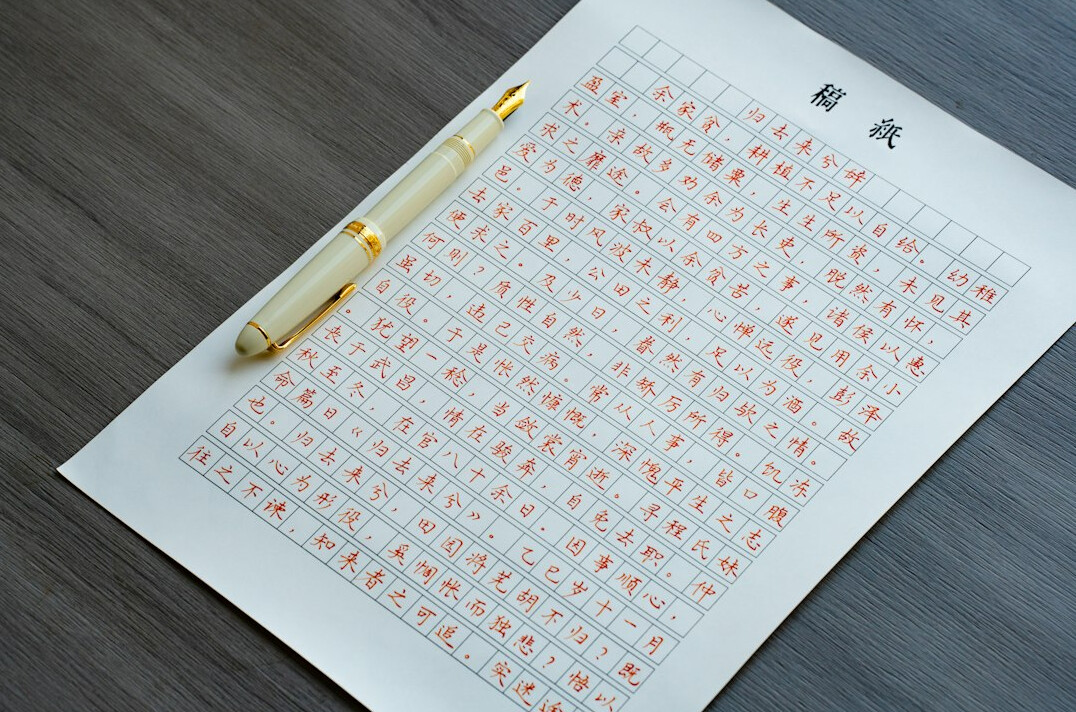 Close-up of printed survey charts and a pen on a desk
